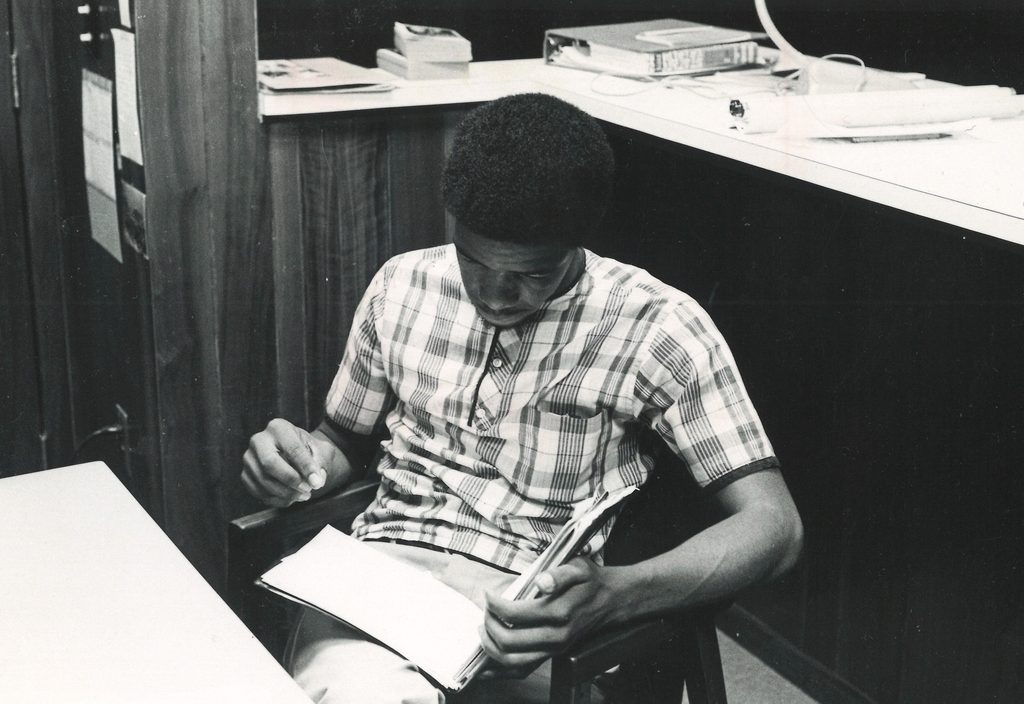 A college student reads from a book.