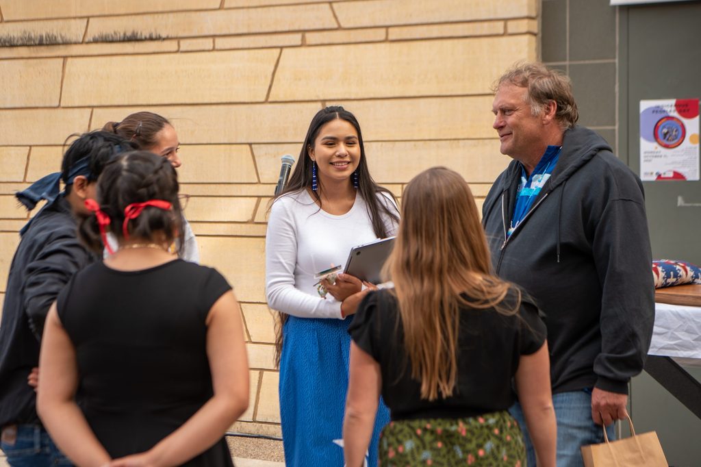 A group of people smiling at Carleton's Indigenous Peoples' Day celebration in 2021.