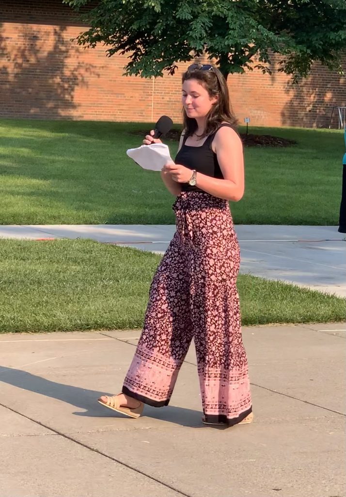 Hannah Sheridan '23 talks into a microphone outside.