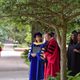 President Alison Byerly and president emeritus Steven Poskanzer talk under a tree.