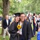 Cee Scallen '20 and Jez Bigornia '20 hug and pose with a sunflower for a different camera.