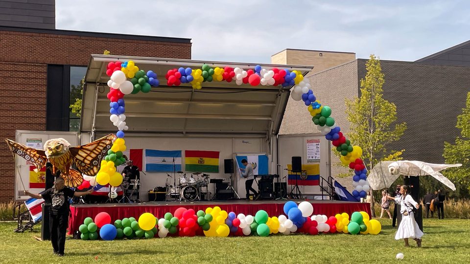 Two puppeteers in front of the Hispanic Heritage Month Celebration stage.