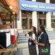 Two students grab popcorn from the popcorn cart in front of Sayles.
