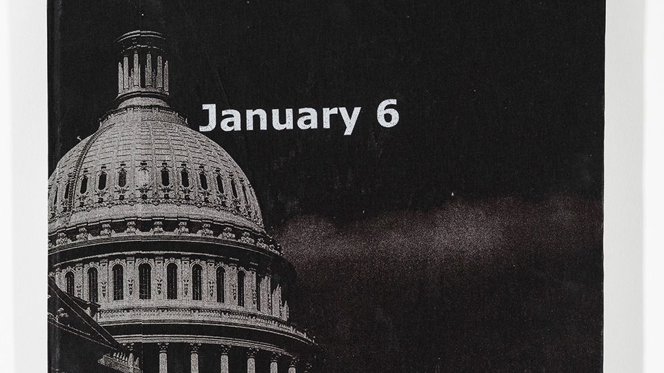 Cloth cover of a book, screenprinted in black and white with an image of the U.S. capitol building and the words