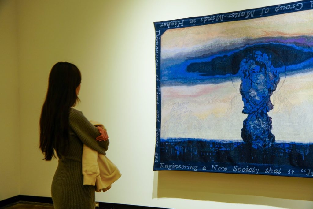 Student viewing wall tapestry