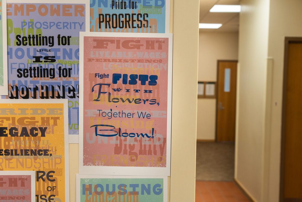 Colorful posters on a wall next to a hallway