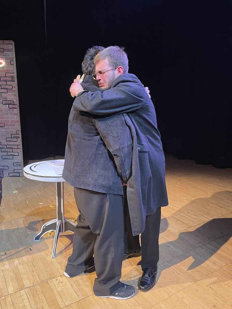 Preves as Louis and Le as Cruncher hug in an emotional moment at the end of the play.