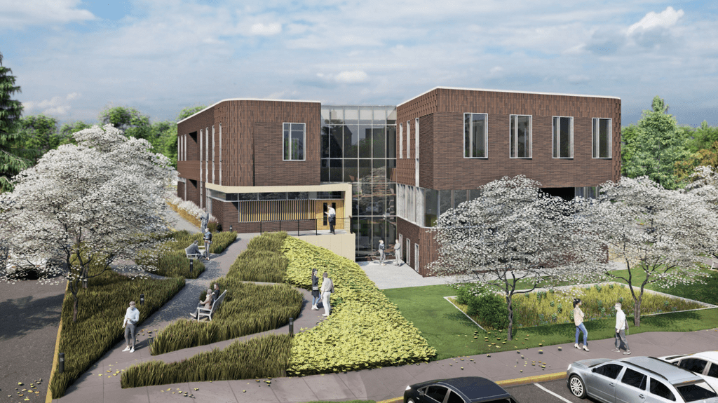 Rendering of a large, brown brick building with big windows, surrounded by grass and trees.