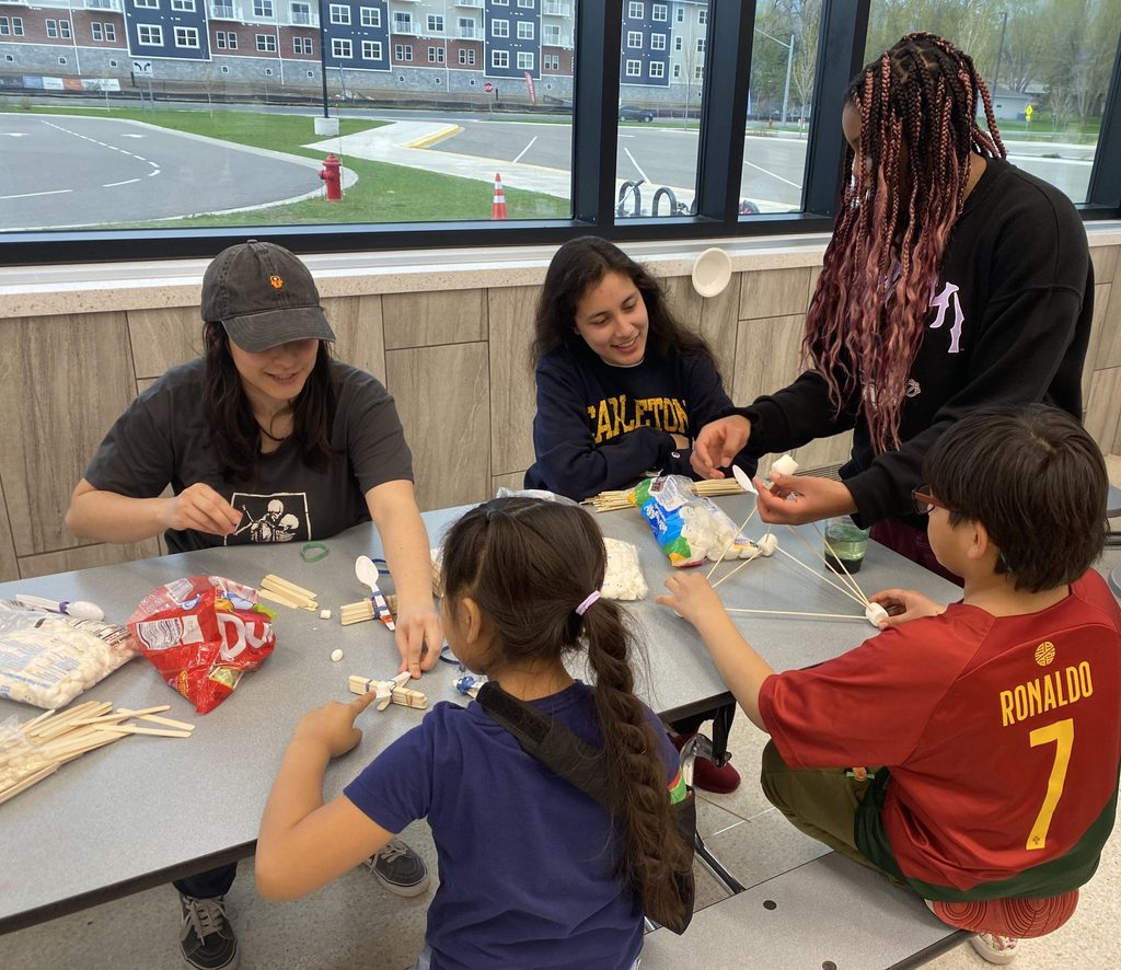 Students building marshmallow catapults together