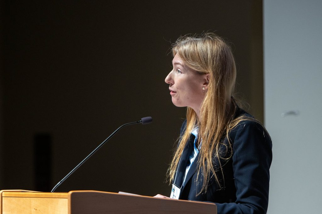 Close-up of Lydia Tang speaking at a podium.