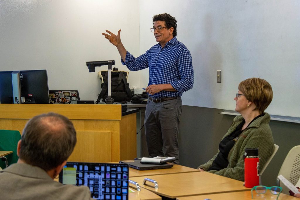 Peter Balaam presents at the front of a classroom.