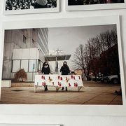 Image of two protestors holding a sign