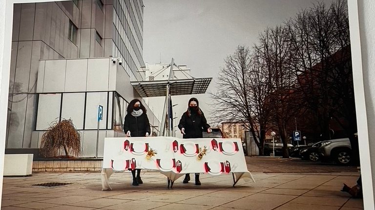 Image of two protestors holding a sign