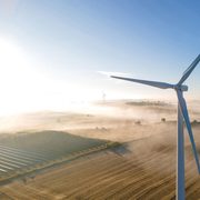 Aerial photo of one of the Carleton wind turbines during a misty early morning.