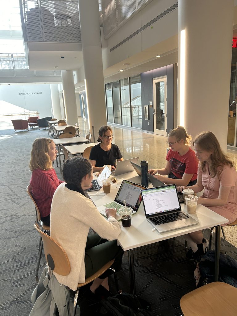 Students and Professor Susannah Ottaway '89 sitting around a table in Anderson Atrium