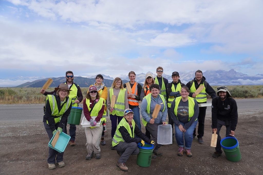 Seed collection volunteers pose with Biologist Jasmine Cutter '13 (blue sweatshirt, center) and Scientist-in-Parks intern Avery Blumenthal (black fleece, right) after a morning collecting antelope bitterbrush seed