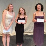 Celia Silverstein ’26 and two other people pose with envelopes.