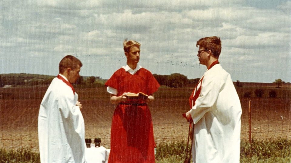 Faded photo of three Carleton students participating in a Druid ceremony.