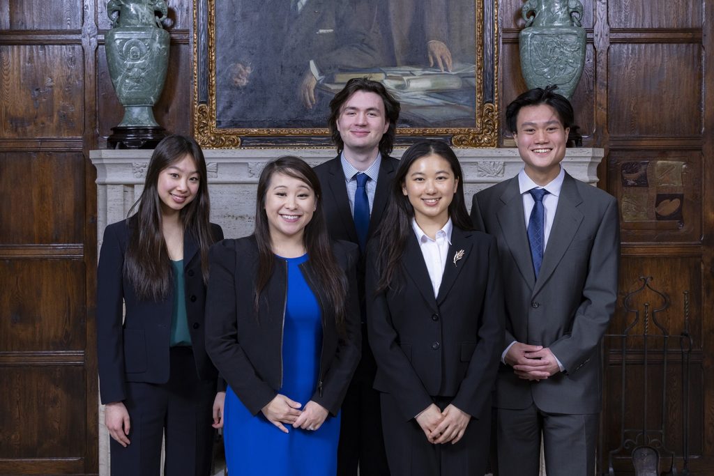 Five students pose in suits.