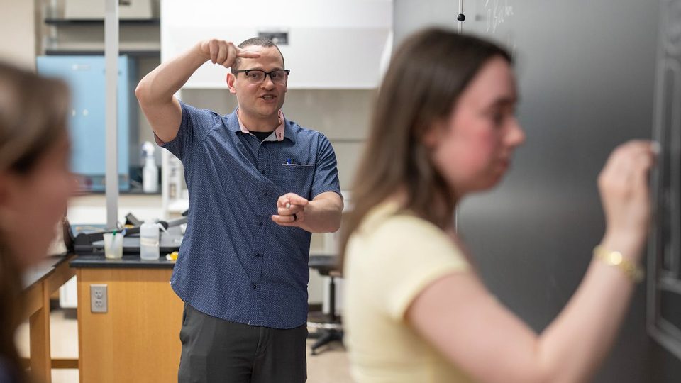 Professor Keenan Hartert guides students in solving a problem during an open hour session at Minnesota State University.