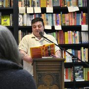 Rafael Frumkin ’12 reading at a podium in Content Bookstore.