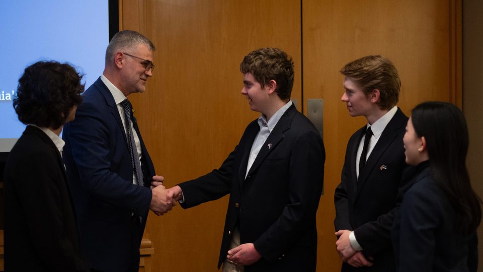 Ambassador Prikk shakes hands with students in the AHS.