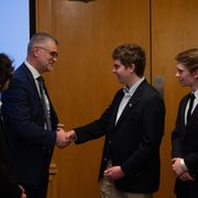 Ambassador Prikk shakes hands with students in the AHS.