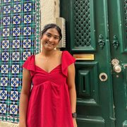 Narjis Nusaibah ’26 poses in front of a green door.