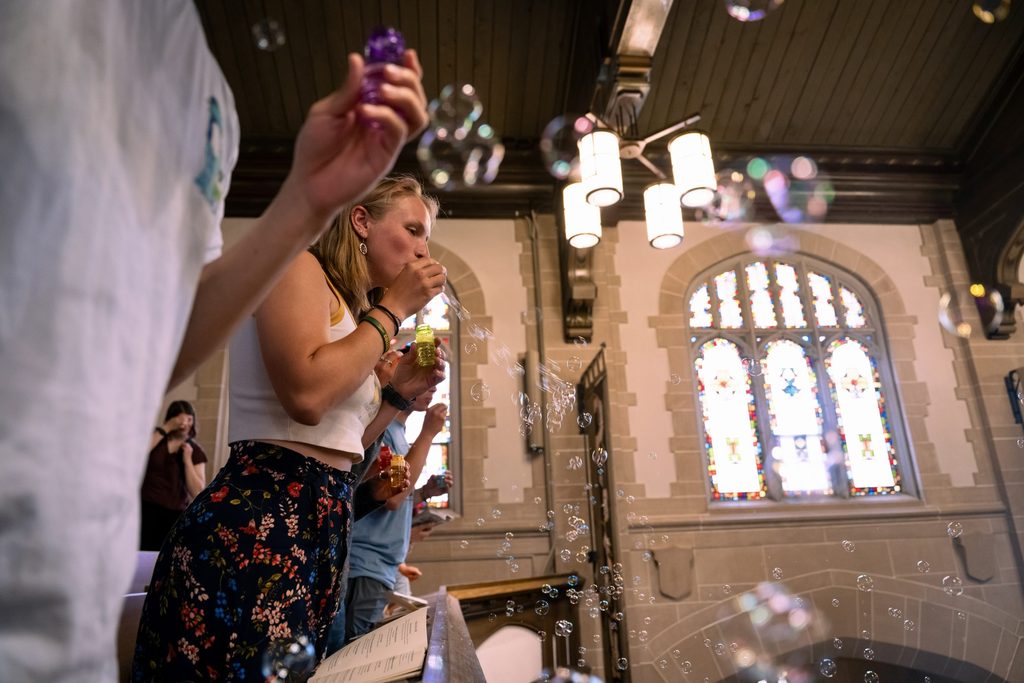 Students blow bubbles from the Chapel balcony at Honors Convo.