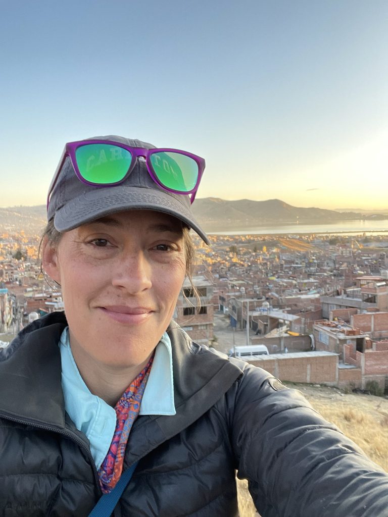 Photo of Sarah Kennedy with a city and lake in the background