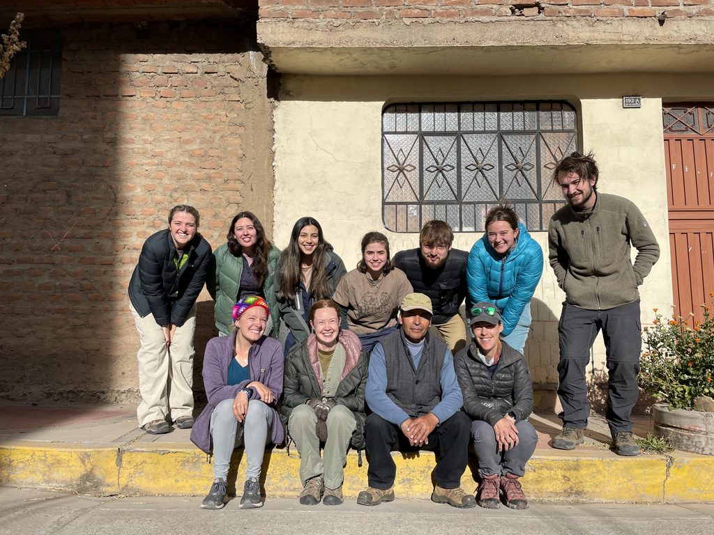 Members of PAMA pose for a photo on the curb in front of a building