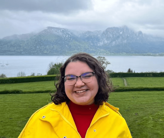 Photo of Sammie in front of a lake