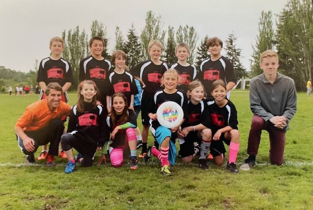 David Evans ’82 poses with the team of young Ultimate players that he coached.