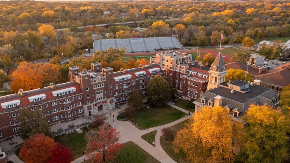 Aerial shot of Willis Hall and Burton, with Laird Stadium in the background, in the fall during sunset.
