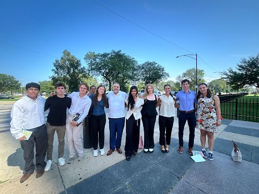 Group photo of people out in courtyard of a courthouse