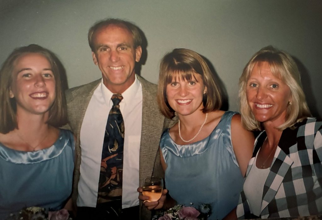 Two students pose with Dave and Donna Ricks.