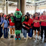 Carleton staff and students pose with the Minnesota Aurora mascot.