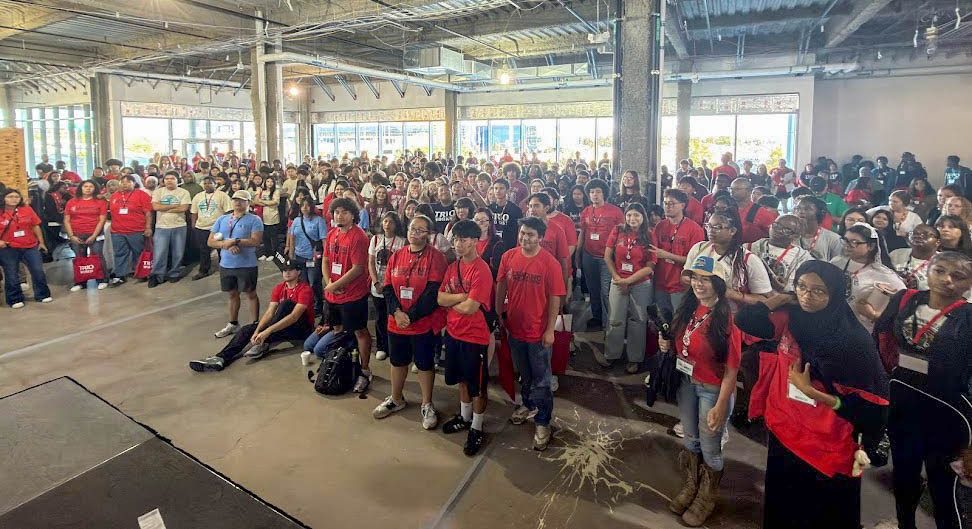 Large crowd of students in an industrial space.