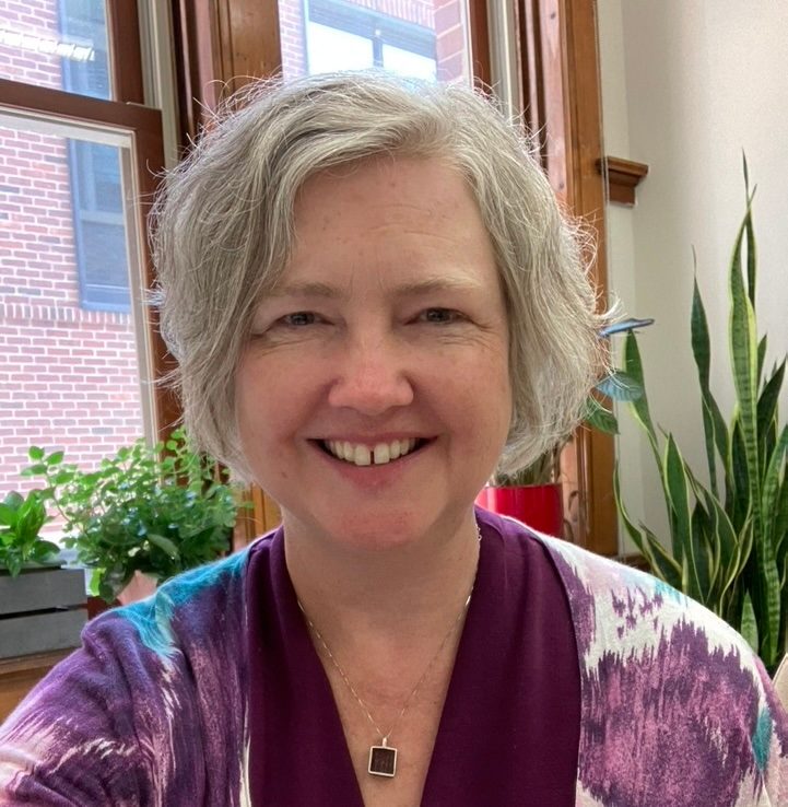 Jennifer Ross_Wolff smiling in front of window