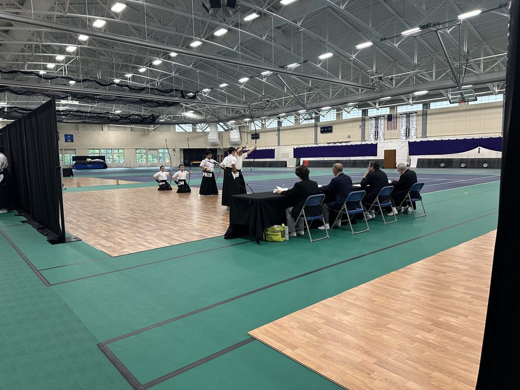 Kyudo practitioners lined up, shooting