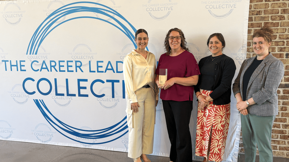 Staff members of the Carleton Career Center pose with their award.