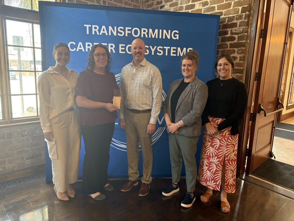 Staff members of the Carleton Career Center pose with the CLC CEO.