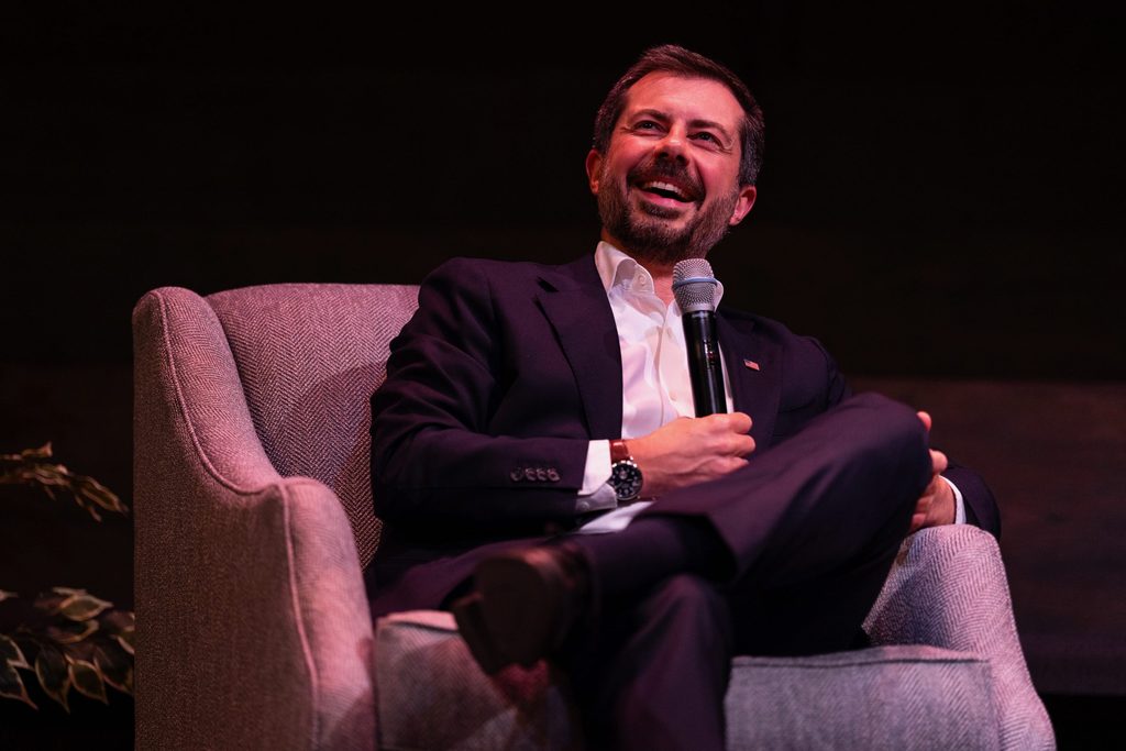 Pete Buttigieg laughs onstage.