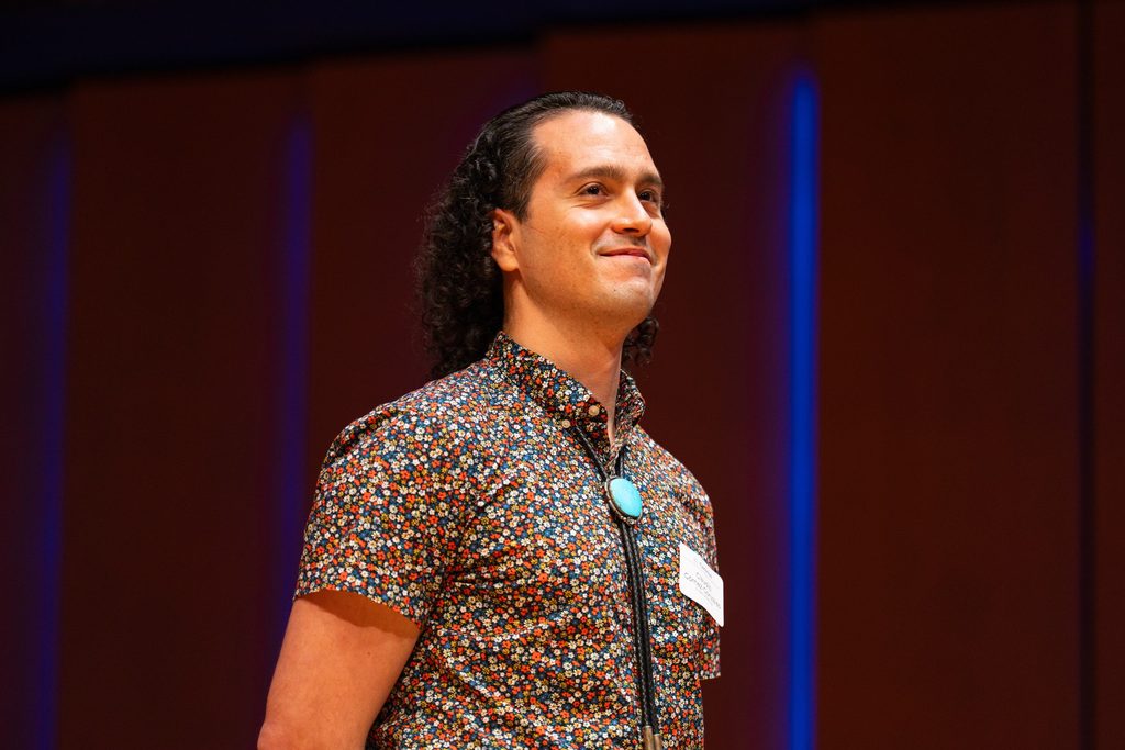Claudio Gómez-Gonzáles smiles as they stand on Kracum stage.