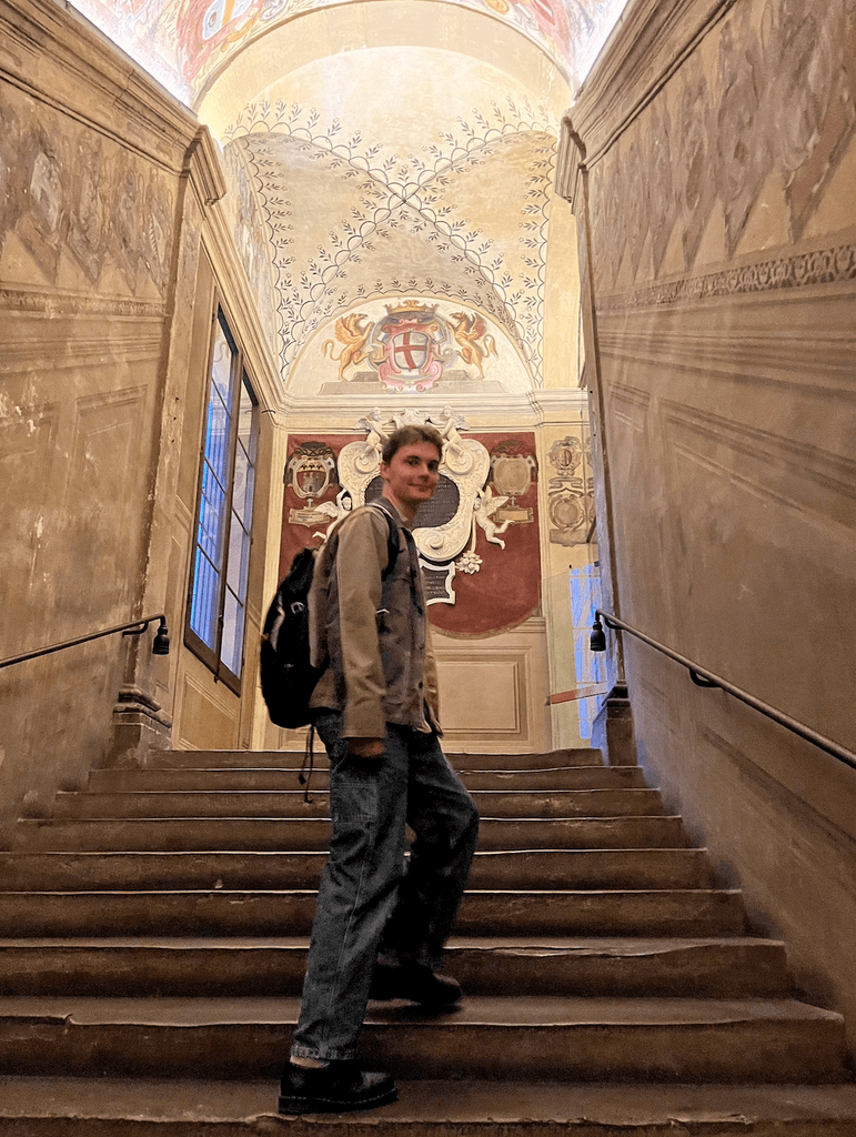 Arthur Koenig ’25 posing on the steps of an Italian building.