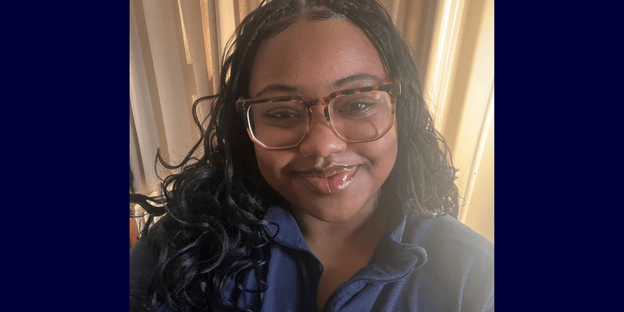 Selfie of Anniya Harris on a dark blue background.
