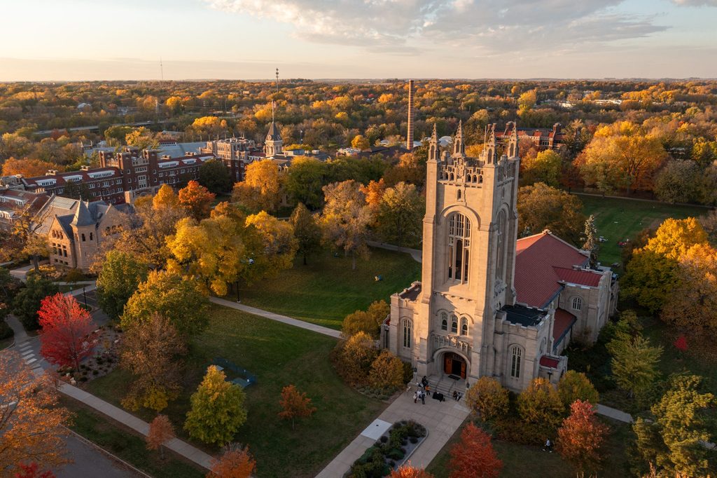 Carleton's campus on a fall day the chapel is visible in the foreground surrounded by trees