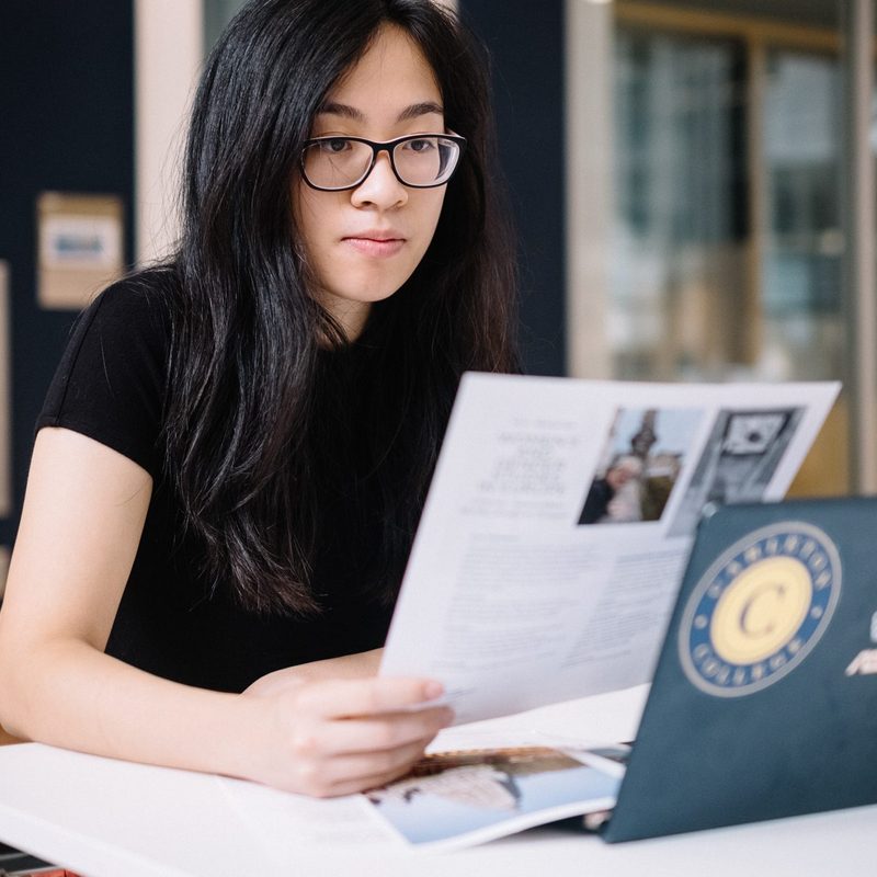 Student reading a brochure