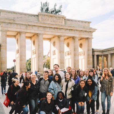 Students posing in a group photo in front of a famous monument