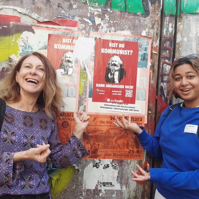 Faculty and student look at murals in Berlin